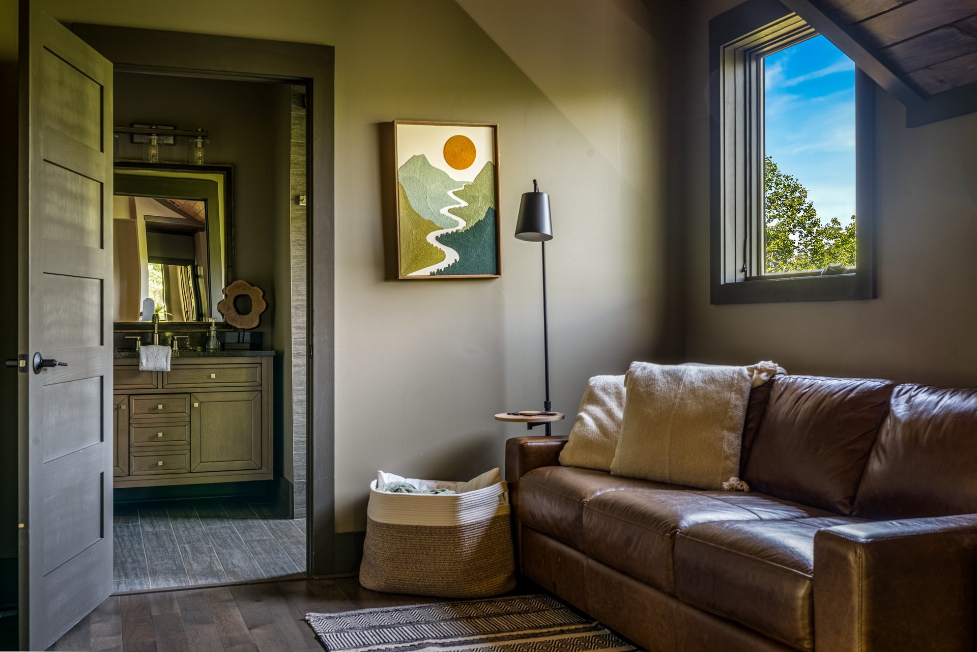 Upstairs gallery sitting area with a leather sleeper sofa