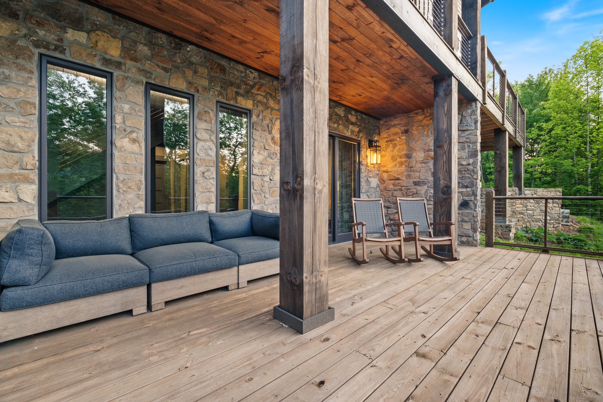 Covered deck with sectional sofa, rocking chairs and cable railings